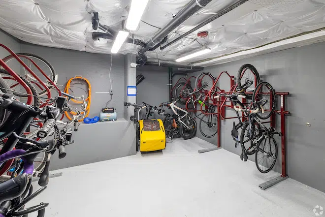 ecure bicycle storage room with wall-mounted bike racks at Admiral Station Apartments in West Seattle.