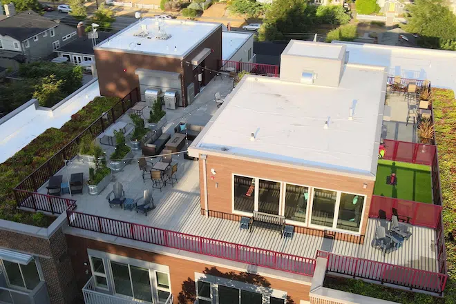Aerial view of the rooftop lounge and outdoor amenities at Admiral Station Apartments.