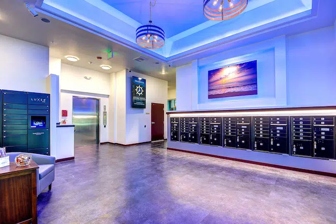 Resident lobby with secure mailboxes, package lockers, and elevator access at Admiral Station Apartments.