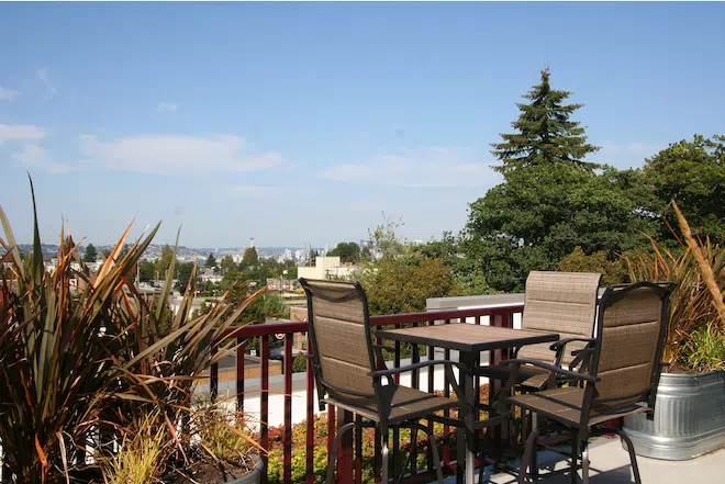 Rooftop seating area overlooking the Seattle skyline from Admiral Station Apartments.